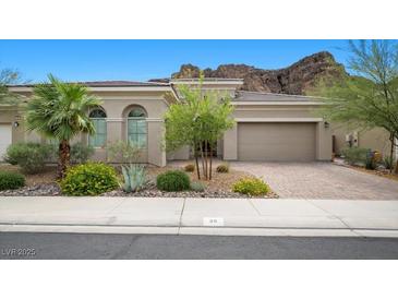 Inviting single-story home with desert landscaping and attached two car garage at 26 Costa Tropical Dr, Henderson, NV 89011