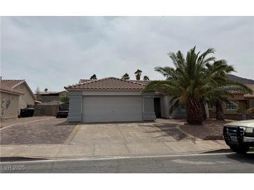 Charming single-story home with a well-maintained front yard and a two-car garage at 341 Waterwheel Falls Dr, Henderson, NV 89015