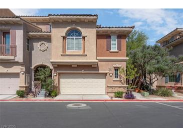 Charming townhome with a two-car garage and landscaped front, offering curb appeal and convenience at 9975 Sand Key St, Las Vegas, NV 89178