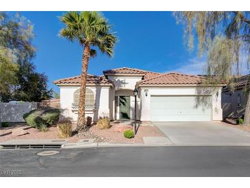 Charming single-story home featuring desert landscaping, a tile roof, and an attached two-car garage at 10518 Santerno St, Las Vegas, NV 89141