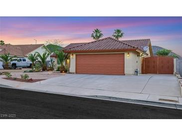 Charming single-story home with a desert landscape, a two-car garage, and a tile roof at 160 Coastal Pier Ct, Henderson, NV 89002