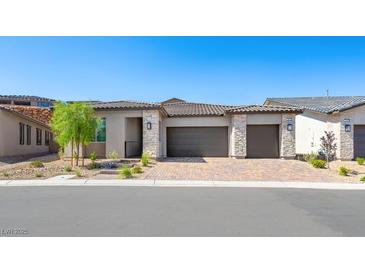 Charming single-story home with a brick driveway and desert landscaping at 362 Tigullio Ave, Henderson, NV 89011