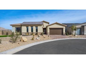 Stylish single-story home featuring desert landscaping, a brown metal roof, and brick-paved driveway at 796 Windover Ct, Las Vegas, NV 89138