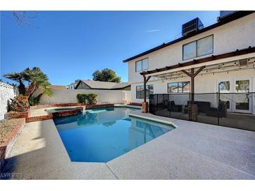 Inviting backyard pool and spa with concrete decking and covered patio, perfect for outdoor entertaining at , Henderson, NV 89014