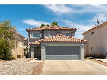 Two-story home featuring a red tile roof, two-car garage, neutral stucco, and low-maintenance desert landscaping at 10162 Lemon Thyme St, Las Vegas, NV 89183