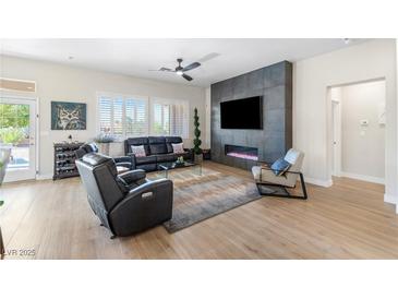 Inviting living room with sleek fireplace feature wall, stylish furniture, and light-filled windows at 10504 Button Willow Dr, Las Vegas, NV 89134