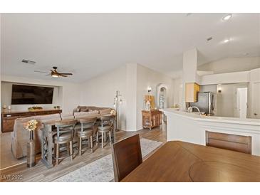 Open-concept living room featuring a breakfast bar, comfortable seating, and modern finishes at 1079 Oak Shade Ln, Henderson, NV 89015