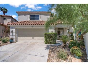 Charming two-story home featuring a well-manicured yard and attached two-car garage at 1305 Chaparral Summit Dr, Las Vegas, NV 89117