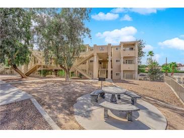 Inviting condo exterior showcasing communal seating area and convenient access to units via exterior stairwells at 2007 Cutlass Dr # 0, Henderson, NV 89014