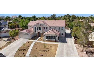 Expansive two-story home with a well-manicured yard and long private drive at 276 Glenridding St, Las Vegas, NV 89183