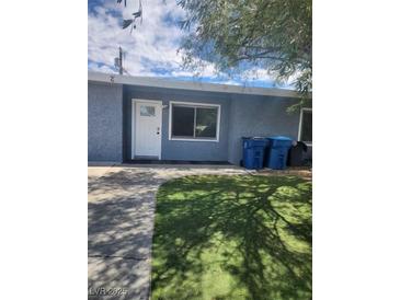Cozy single-story home with a well-maintained lawn and blue exterior paint at 324 Princeton St, Las Vegas, NV 89107