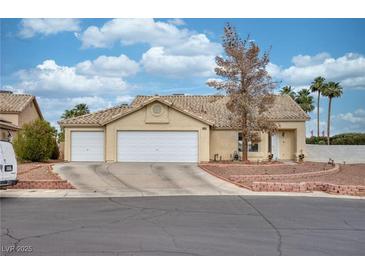 Charming single-story home featuring a three-car garage, low maintenance landscape, and a tile roof at 4878 Califa Dr, Las Vegas, NV 89122