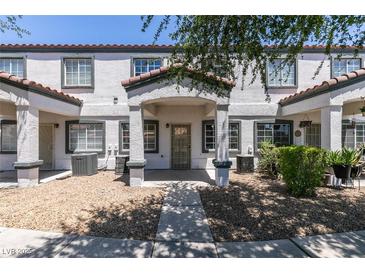 Charming townhome featuring a quaint front porch and well-maintained gravel landscaping for added curb appeal at 5330 E Charleston Blvd # 2, Las Vegas, NV 89142