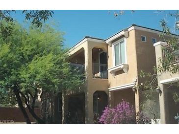 Charming two-story home featuring stucco siding, balcony, and desert landscaping at 6927 Smiling Cloud Ave, Henderson, NV 89011