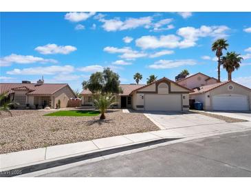 Charming single-story home featuring a well-maintained gravel yard, mature trees and an attached two-car garage at 8000 Vista Twilight Dr, Las Vegas, NV 89123