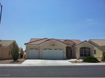 Charming single-story home with a two-car garage and a well-maintained front yard landscape at 8545 Summer Vista Ave, Las Vegas, NV 89145