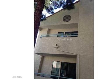 A clean, two-story condo with stucco siding and private balconies on each level at 910 N Sloan Ln # 201, Las Vegas, NV 89110