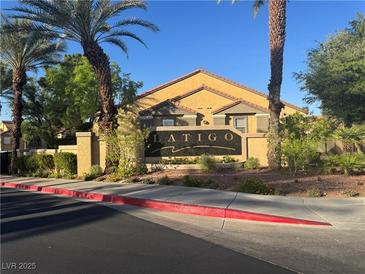 View of the Latigo community entrance sign flanked by mature palm trees and lush landscaping at , Las Vegas, NV 89183