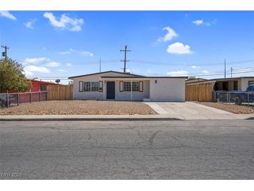 Charming single-story home with neutral desert landscaping, and a well-maintained exterior at 1115 W Nelson Ave, North Las Vegas, NV 89030