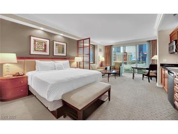 Comfortable suite featuring a king-size bed, city views, and a kitchenette at 135 E Harmon Ave # 315, Las Vegas, NV 89109