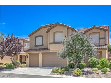 Charming two-story home with tile roof, two-car garage, and professionally landscaped yard at 2189 De Narvik Dr, Henderson, NV 89044