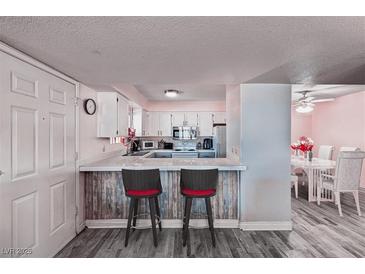 Charming kitchen features a breakfast bar with seating, and a view of the dining area at 2725 S Nellis Blvd # 1038, Las Vegas, NV 89121