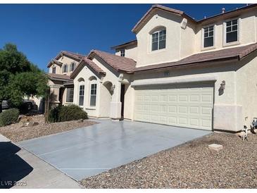 Two-story home features a two car garage, desert landscaping, and neutral paint scheme at 3728 Prairie Orchid Ave, North Las Vegas, NV 89081