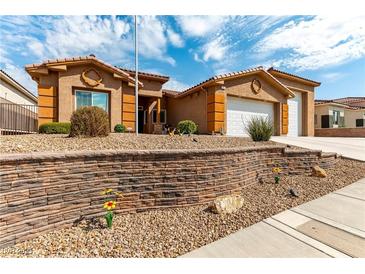 Charming single-story home showcasing xeriscaping, multi-car garage, and a beautifully contrasting stucco exterior at 3811 Queen Elizabeth Ct, Laughlin, NV 89029
