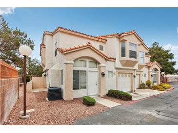 Attractive two-story townhome featuring a red tile roof and stucco exterior, with a one-car garage at 6812 Coral Rock Dr, Las Vegas, NV 89108