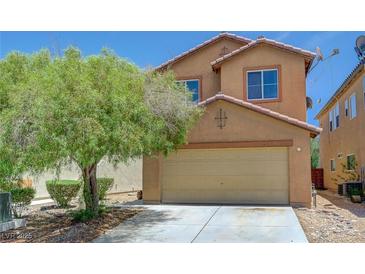 Charming two-story home with a two-car garage and mature tree in the front yard at 7464 Edgecove Ct, Las Vegas, NV 89139