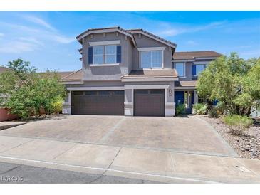 Charming two-story home showcasing a three-car garage, neutral paint, and a well-maintained front yard at 93 Autumn Day St, Henderson, NV 89012