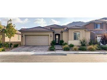 Charming single-story home featuring desert landscaping, a tile roof, and an attached two-car garage at 9537 Wild Valley Ave, Las Vegas, NV 89148