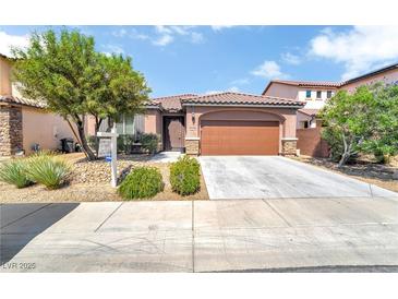 Charming single-story home features a well-manicured yard, desert landscaping, and a two-car garage at 10247 Jamapa Dr, Las Vegas, NV 89178