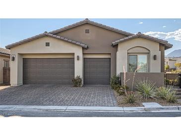 Charming home featuring a three-car garage, low-maintenance landscaping, and a welcoming exterior at 157 Sarabeth St, Las Vegas, NV 89138