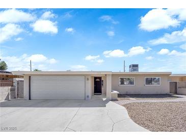 Charming single-story home with a well-maintained front yard and a two-car garage at 1628 Patricia St, North Las Vegas, NV 89030