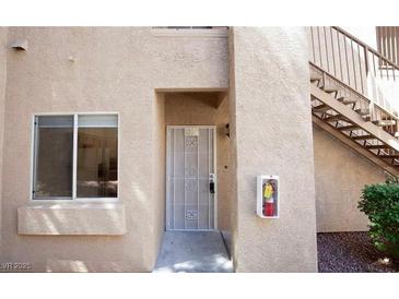 Tan exterior with security door, window, and fire extinguisher box at 2110 Los Feliz St # 1034, Las Vegas, NV 89156