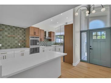 Modern kitchen featuring white cabinets, stainless steel appliances, and a large island at 3647 Ottawa Cir, Las Vegas, NV 89169