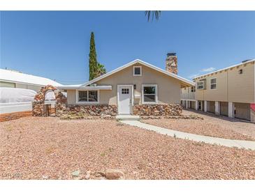 Charming single-story home with a unique stone facade and inviting walkway at 659 D Ave, Boulder City, NV 89005