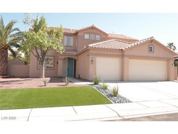 Charming two-story home featuring a tile roof, three-car garage and manicured front yard, creating a welcoming curb appeal at 825 Cornerstone Pl, North Las Vegas, NV 89031