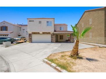 Two-story home featuring a two-car garage and porte-cochere, enhanced with stone accents at 845 Bladensburg St, Las Vegas, NV 89110