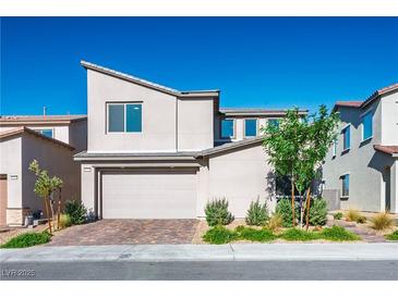 Modern two-story home with a two-car garage and a well-manicured front yard at 9476 Lunar Phase St, Las Vegas, NV 89143