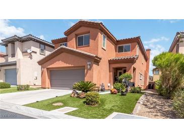Charming two-story home featuring a well-manicured lawn, two-car garage and tasteful desert landscaping at 174 Augusta Course Ave, Las Vegas, NV 89148