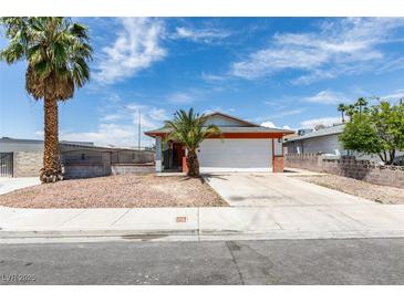 Charming single-story home featuring desert landscaping, an attached garage, and mature palm trees at 2116 Cameron St, Las Vegas, NV 89102