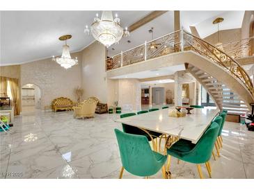 Spacious living room with marble floors, a grand staircase, and ornate chandeliers at 2131 Diamond Bar Dr, Las Vegas, NV 89117