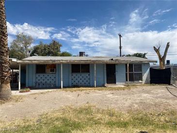 Modest single-story home featuring a light blue exterior, covered porch, and desert landscaping at 2642 San Vincente Ct, Las Vegas, NV 89115