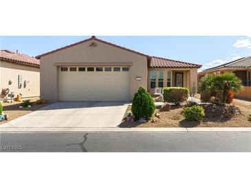 Charming single-story home featuring a two-car garage, desert landscaping and well maintained lawn at 3621 Jasmine Heights Ave, North Las Vegas, NV 89081