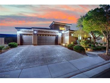 Charming single-story home with a three-car garage, lovely landscaping, and a brick driveway at 7300 Fresh Harvest Ave, Las Vegas, NV 89131