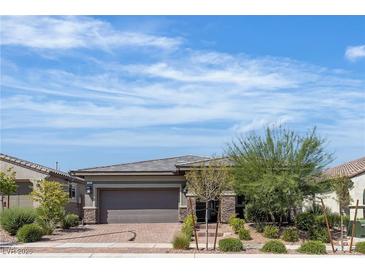 Charming single-story home boasts a well-manicured front yard and a two-car garage at 789 Drammatico Pl, Henderson, NV 89011