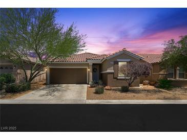 Charming single-story home featuring a well-maintained yard and attached two-car garage in a desirable community at 9104 Ashiwi Ave, Las Vegas, NV 89178