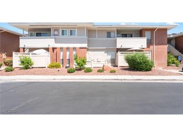 Inviting condo featuring a well-maintained exterior with red rock landscaping and quaint, fenced-in patio area at 2866 Loveland Dr # 2018, Las Vegas, NV 89109